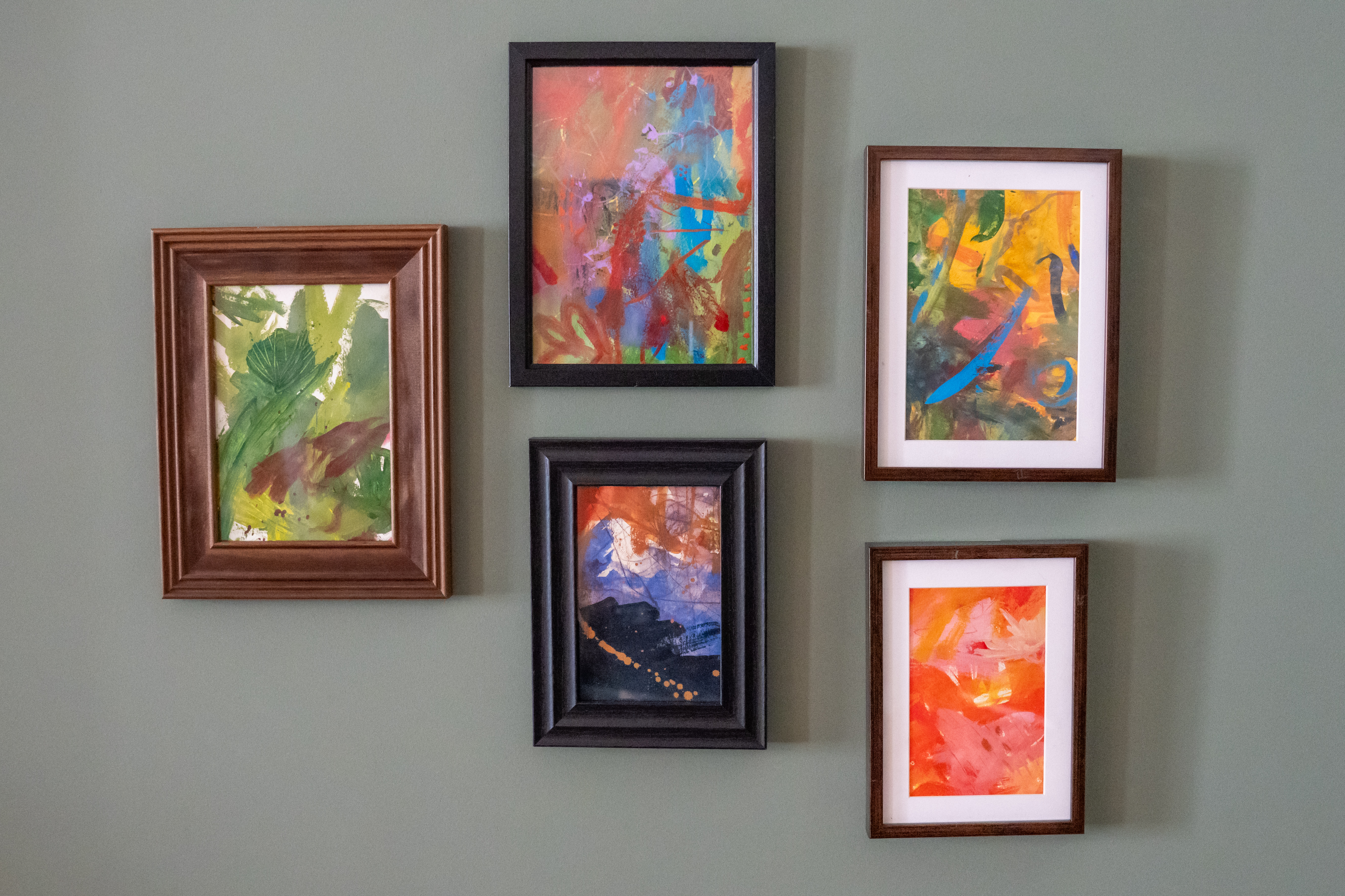 Framed abstract pieces hanging on the wall